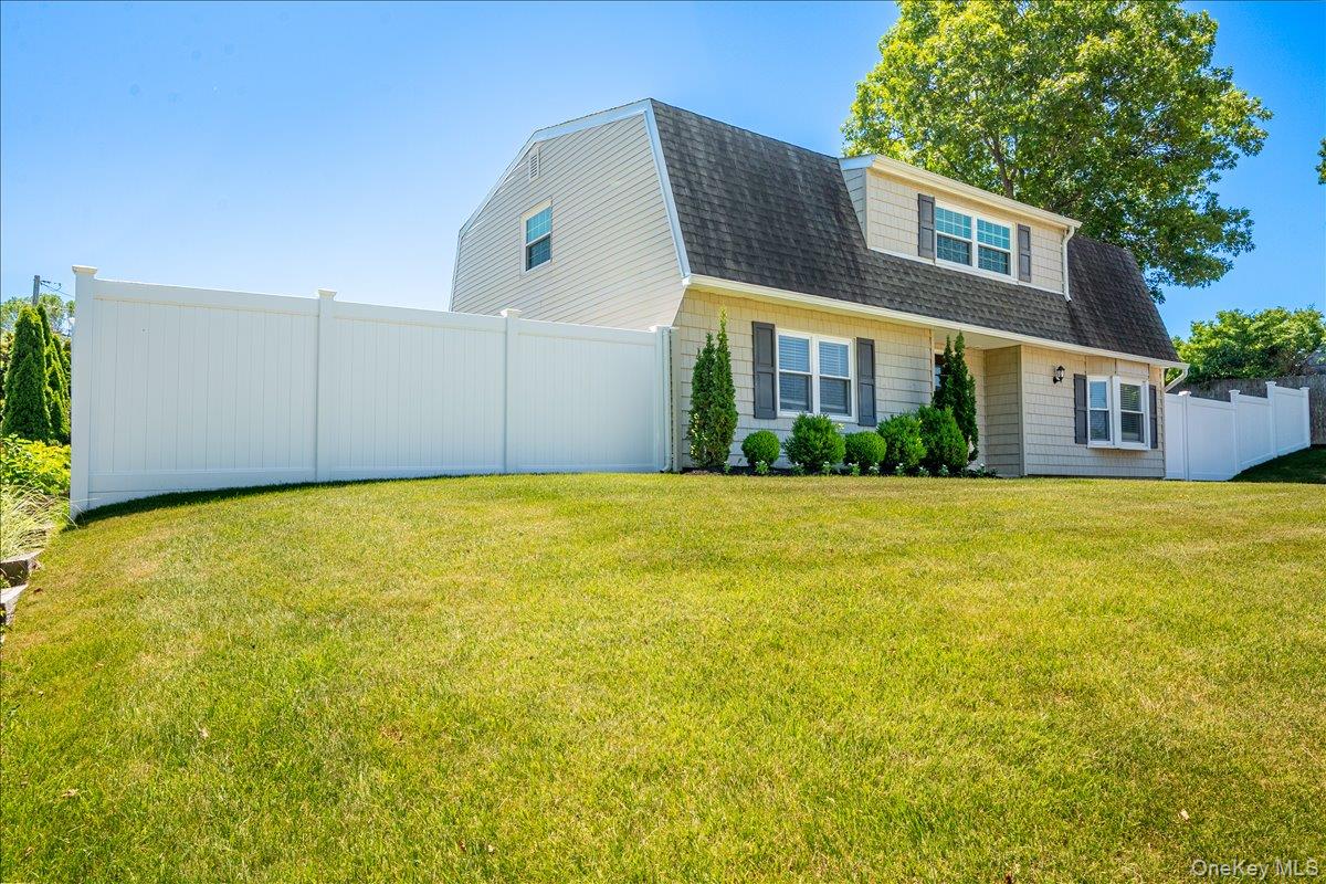 10 Rutgers Road Farmingville, NY 11738 - Photo 2 of 27 a front view of house with yard and trees around