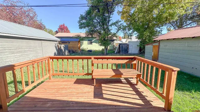 a view of deck with a table and chairs with wooden floor and fence