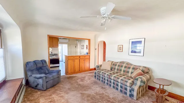 a living room with furniture and a chandelier