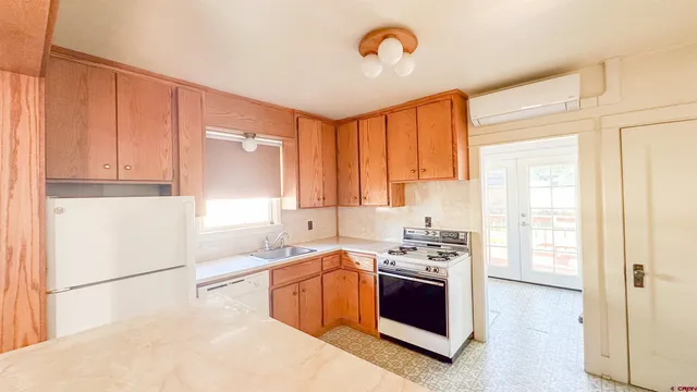 a kitchen with a stove a sink and a refrigerator