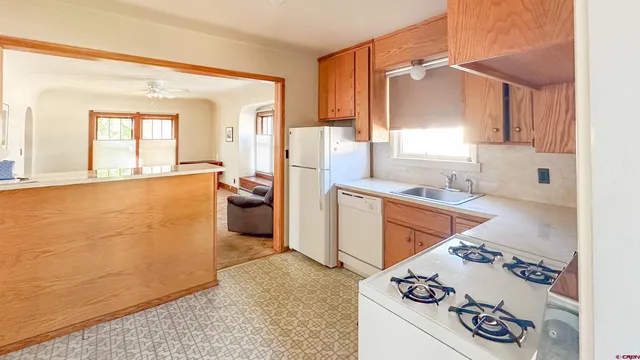 a kitchen with a sink stove and cabinets
