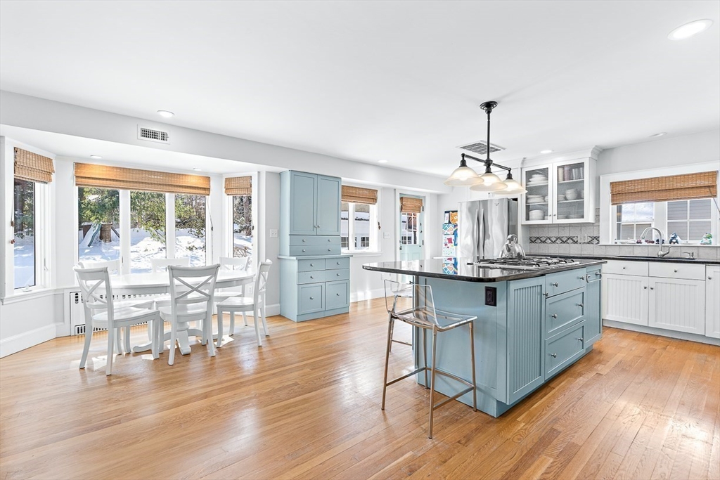 23 Jefferson Road Winchester, MA 01890 - Photo 1 of 41 a kitchen with stainless steel appliances a dining table chairs and wooden floor