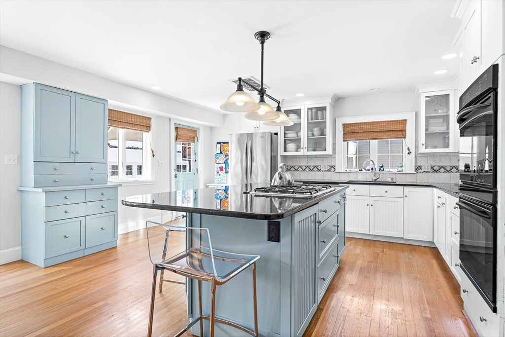 23 Jefferson Road Winchester, MA 01890 - Photo 11 of 41 a kitchen with a stove a sink and wooden floor