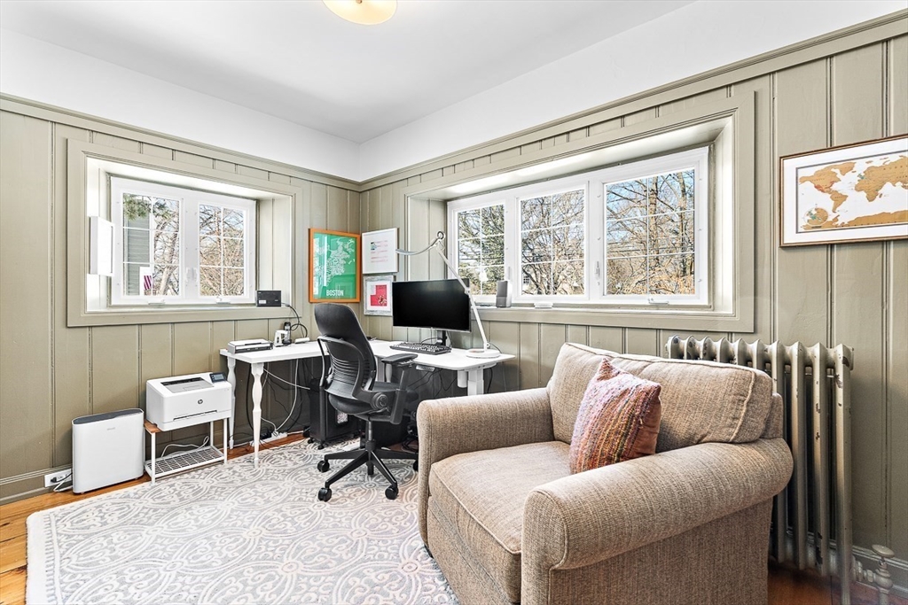 23 Jefferson Road Winchester, MA 01890 - Photo 17 of 41 a living room with furniture a flat screen tv and a window