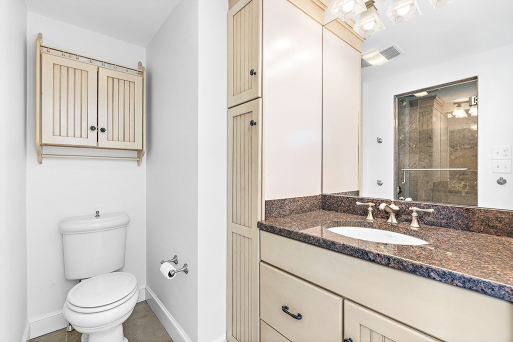 23 Jefferson Road Winchester, MA 01890 - Photo 24 of 41 a bathroom with a granite countertop sink toilet and shower