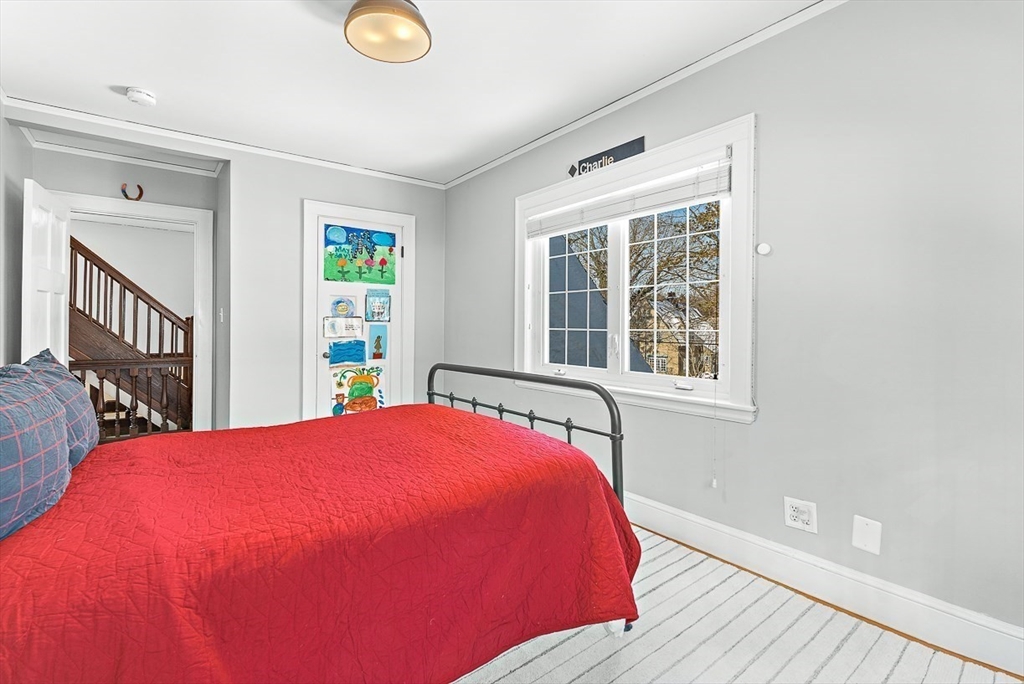23 Jefferson Road Winchester, MA 01890 - Photo 29 of 41 a view of a bedroom with wooden floor and windows