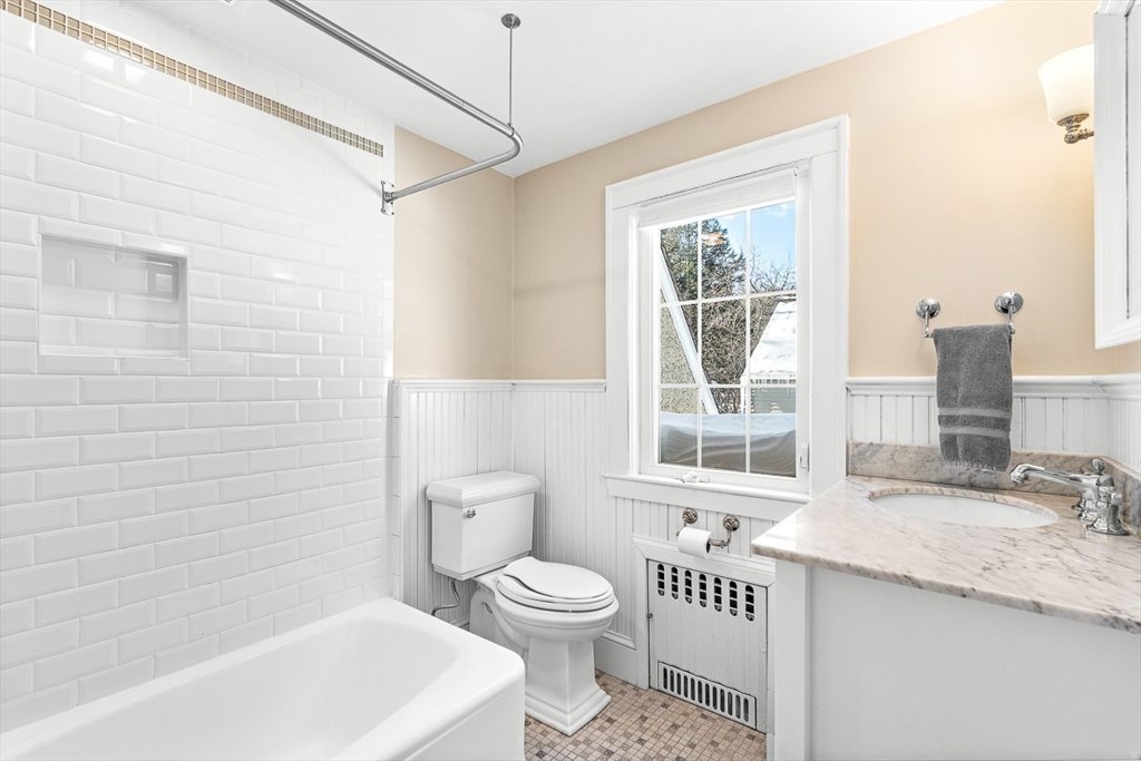 23 Jefferson Road Winchester, MA 01890 - Photo 30 of 41 a bathroom with a granite countertop sink toilet a large mirror and a tub