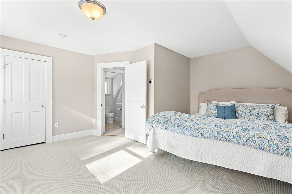 23 Jefferson Road Winchester, MA 01890 - Photo 37 of 41 a bedroom with a bed and lamp