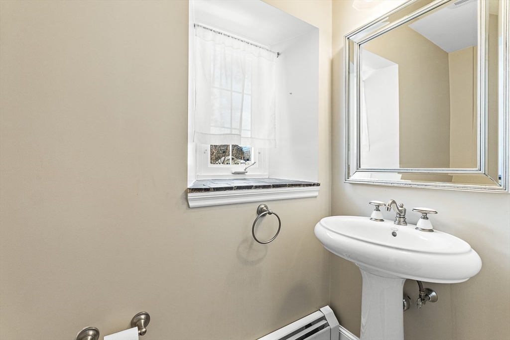 23 Jefferson Road Winchester, MA 01890 - Photo 40 of 41 a bathroom with a sink and a mirror