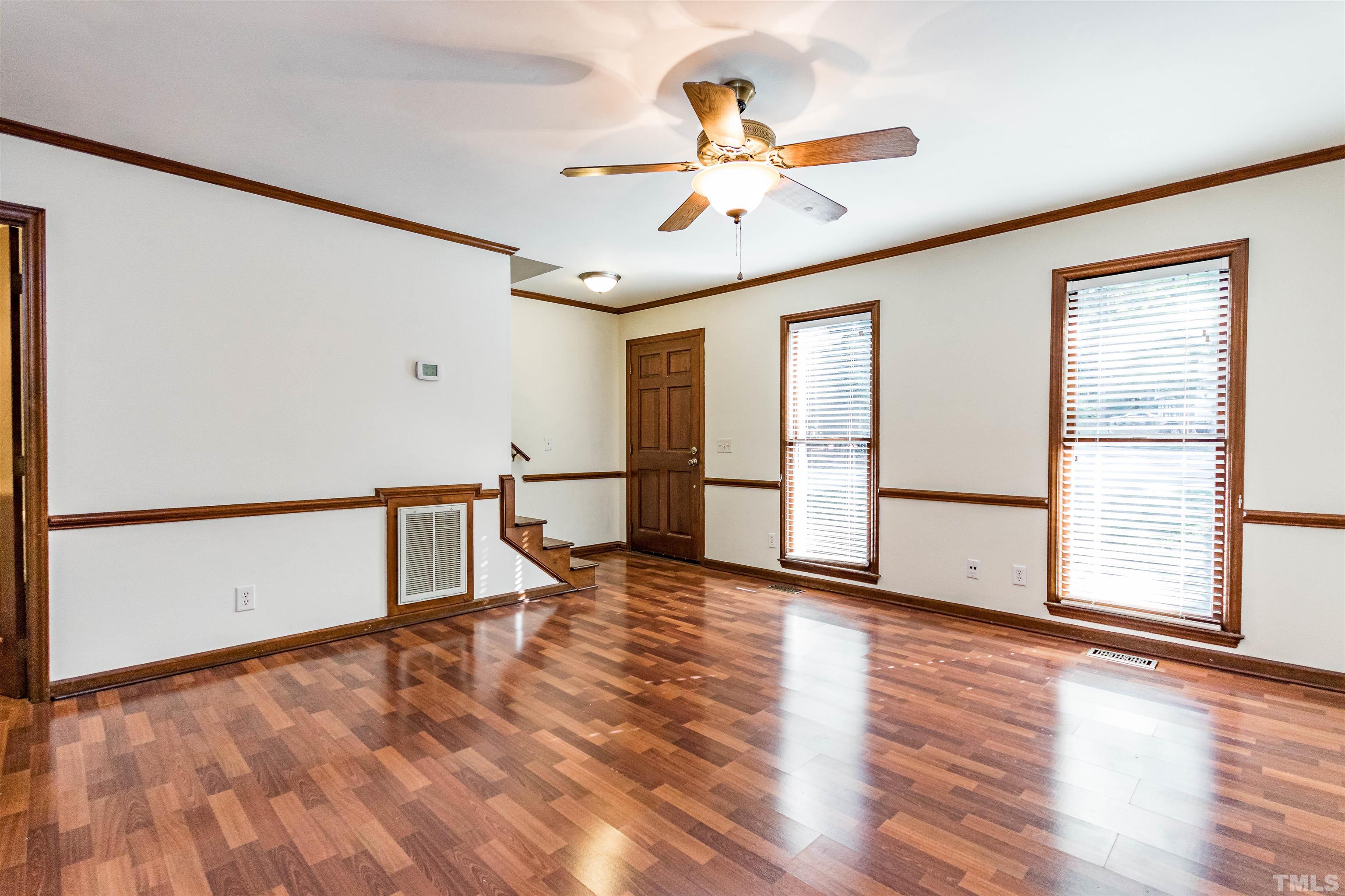 5218 Deer Haven Drive, Unit 5218 Raleigh, NC 27606 - Photo 12 of 27 a view of an empty room with window and wooden floor