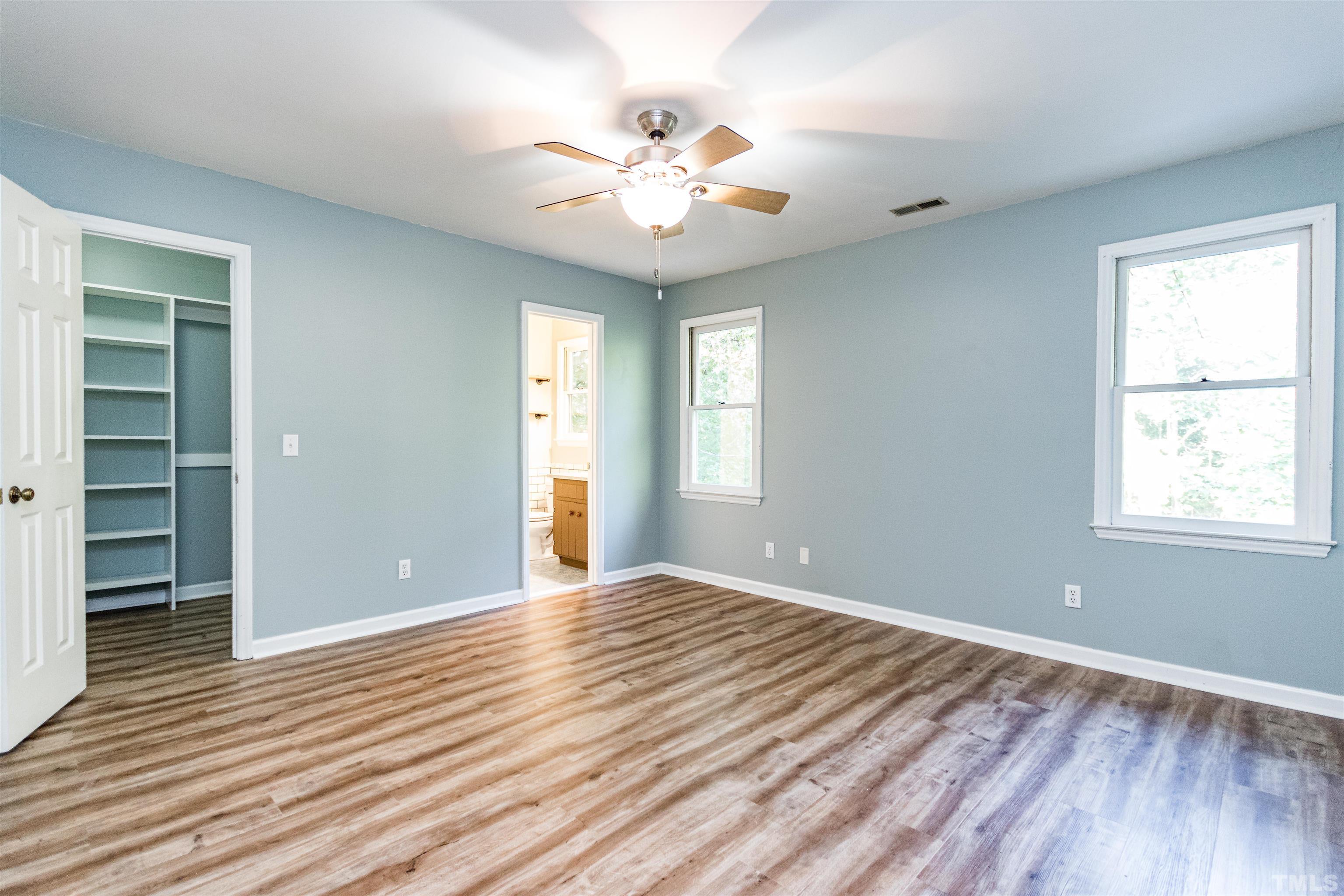 5218 Deer Haven Drive, Unit 5218 Raleigh, NC 27606 - Photo 15 of 27 a view of an empty room with wooden floor and a window