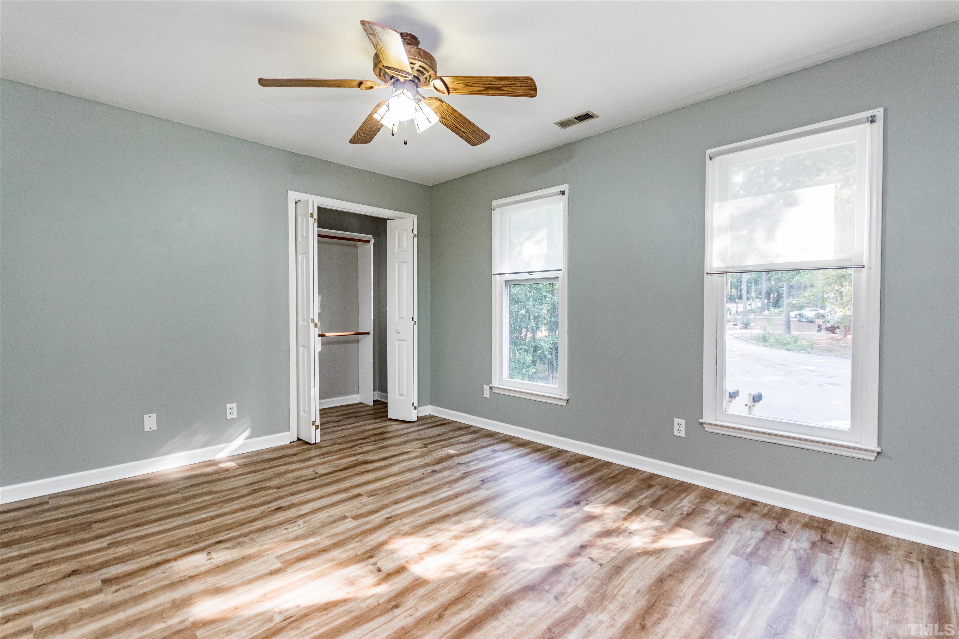 5218 Deer Haven Drive, Unit 5218 Raleigh, NC 27606 - Photo 19 of 27 a view of an empty room with window and wooden floor