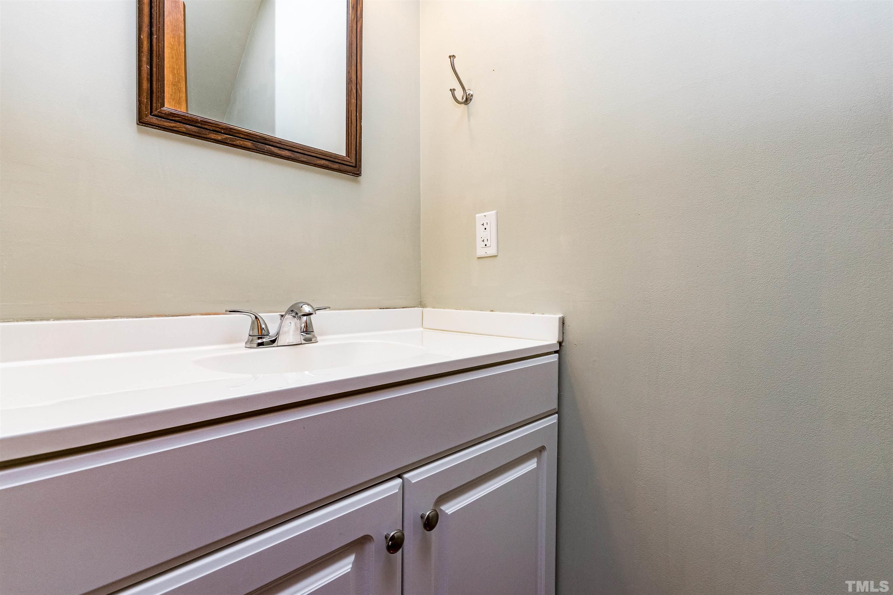 5218 Deer Haven Drive, Unit 5218 Raleigh, NC 27606 - Photo 20 of 27 a bathroom with a sink and a mirror