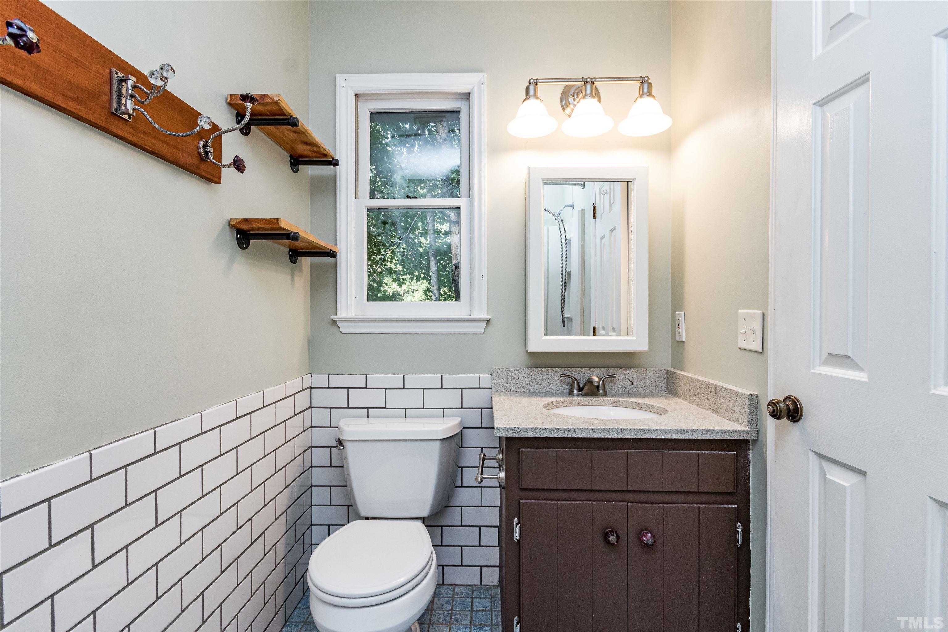 5218 Deer Haven Drive, Unit 5218 Raleigh, NC 27606 - Photo 22 of 27 a bathroom with a sink a toilet and shower