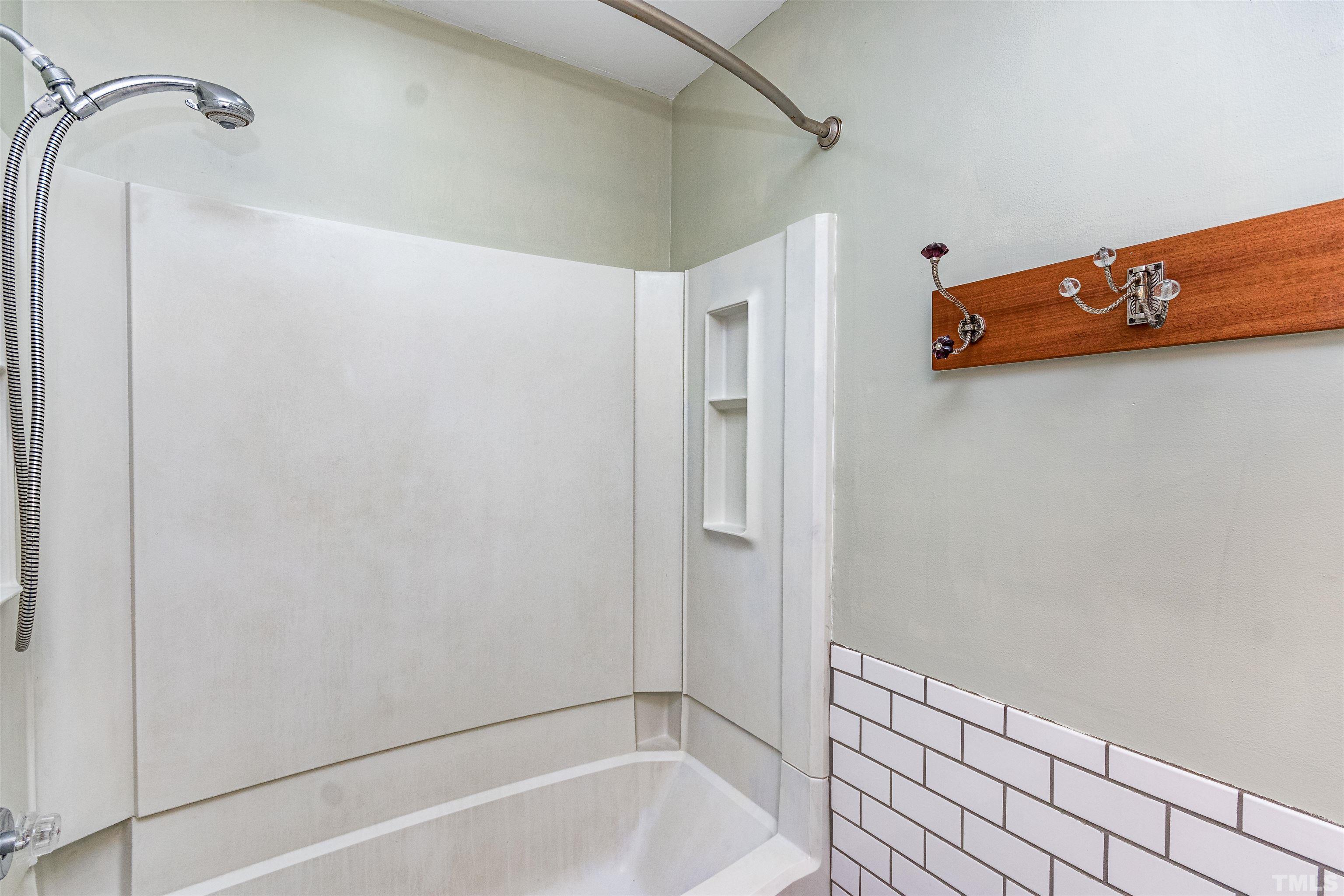 5218 Deer Haven Drive, Unit 5218 Raleigh, NC 27606 - Photo 23 of 27 a bathroom with a bathtub and a shower