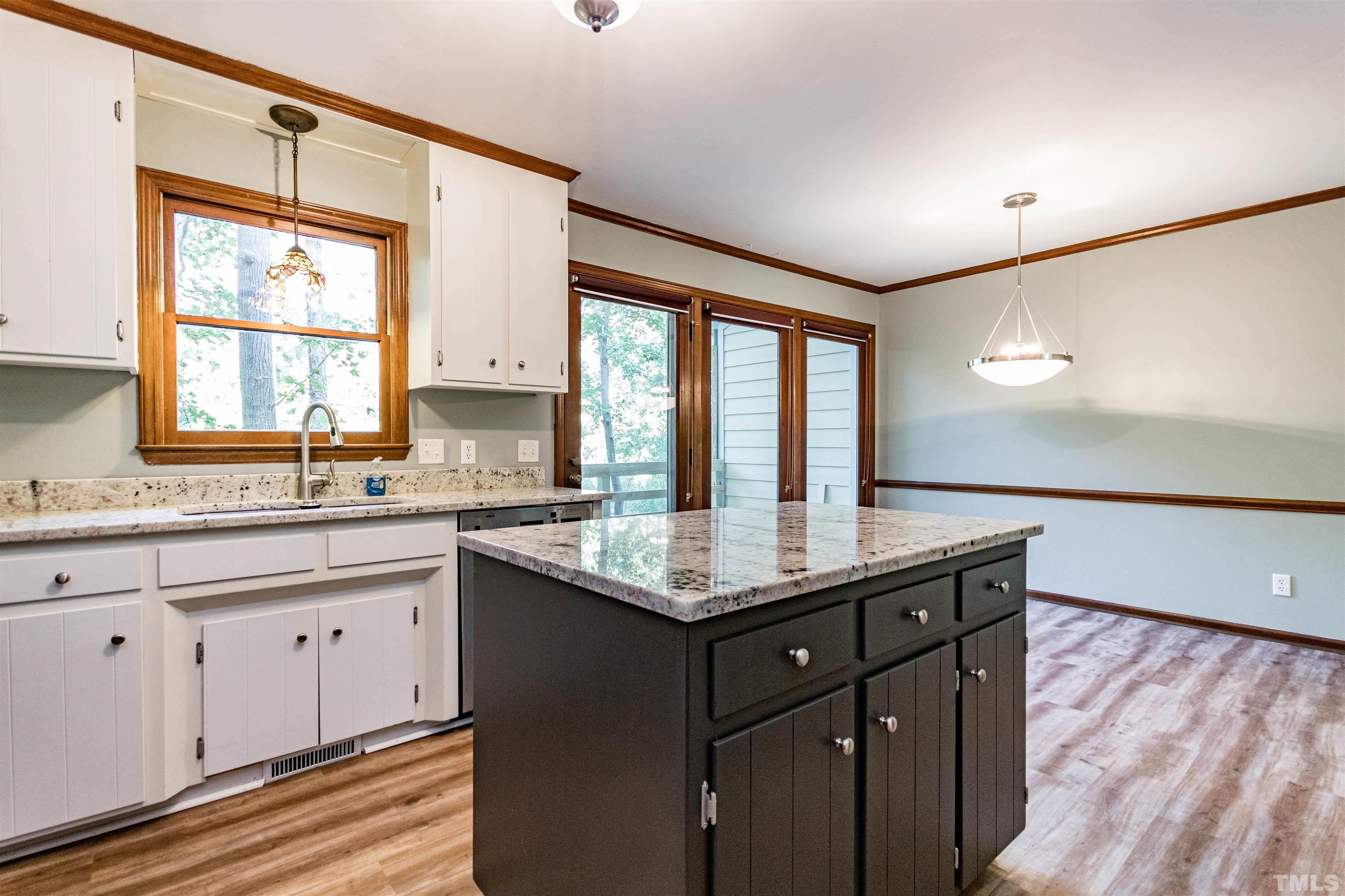 5218 Deer Haven Drive, Unit 5218 Raleigh, NC 27606 - Photo 6 of 27 a kitchen with granite countertop a sink and a window