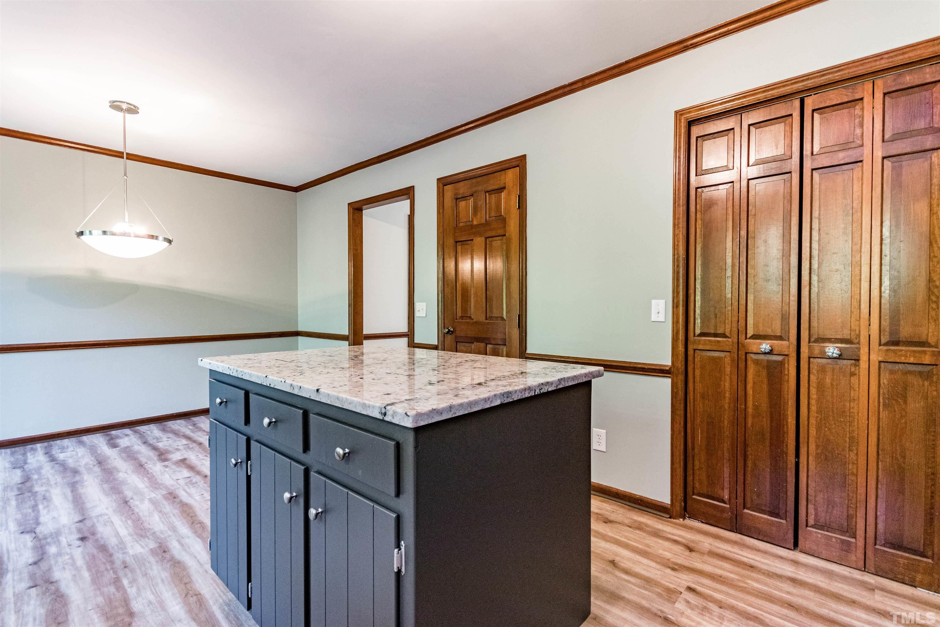 5218 Deer Haven Drive, Unit 5218 Raleigh, NC 27606 - Photo 7 of 27 a kitchen with a granite countertop sink and wooden floor