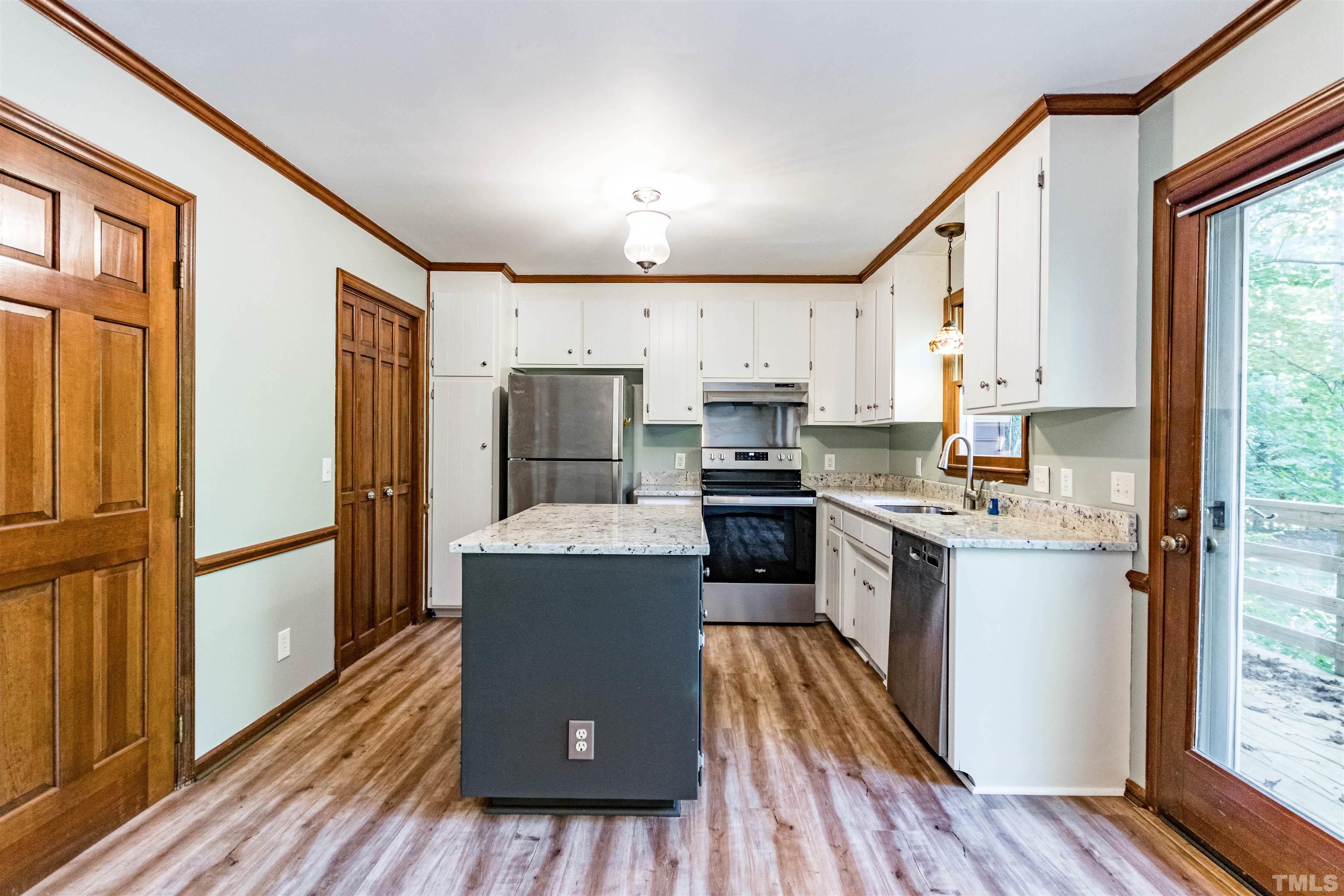 5218 Deer Haven Drive, Unit 5218 Raleigh, NC 27606 - Photo 8 of 27 a kitchen with stainless steel appliances a refrigerator and a stove top oven