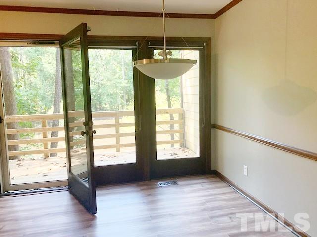5218 Deer Haven Drive, Unit 5218 Raleigh, NC 27606 - Photo 10 of 27 a room with window and wooden floor