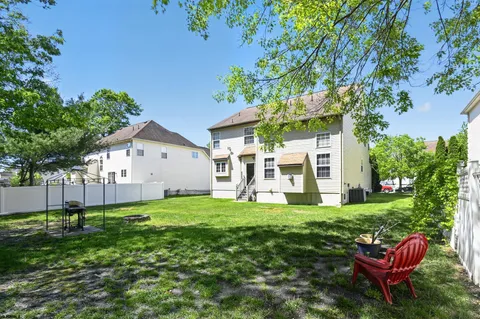 a view of a house with a yard and sitting area