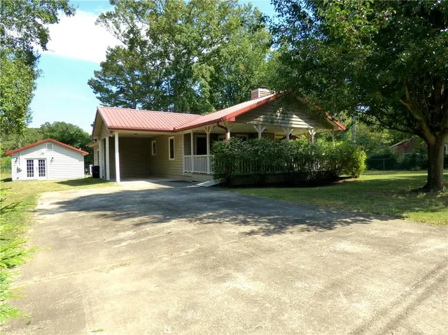 a front view of house with yard and green space