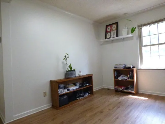 a room with wooden floor and window