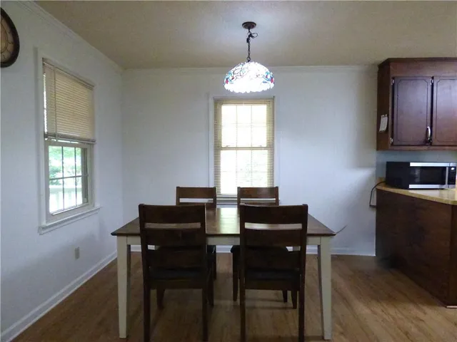 a view of a dining room with furniture and windows