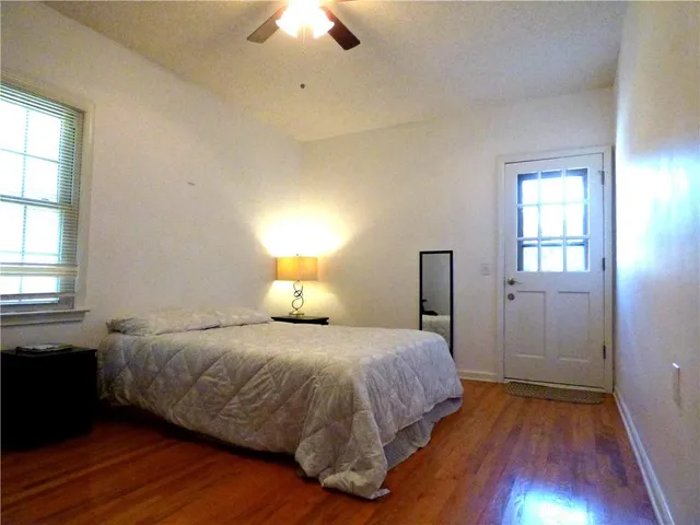 a bedroom with a bed and wooden floor