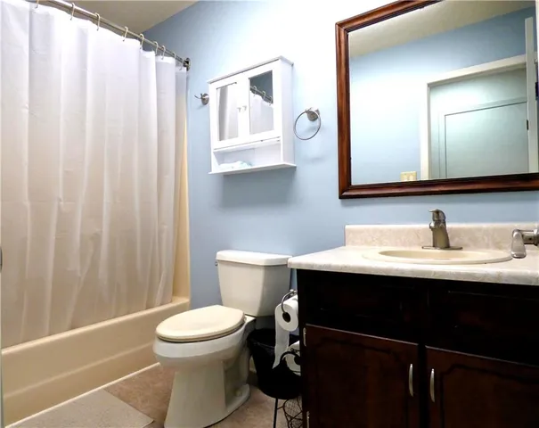 a bathroom with a toilet a sink and a mirror