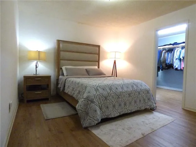 a bedroom with a bed and a lamp