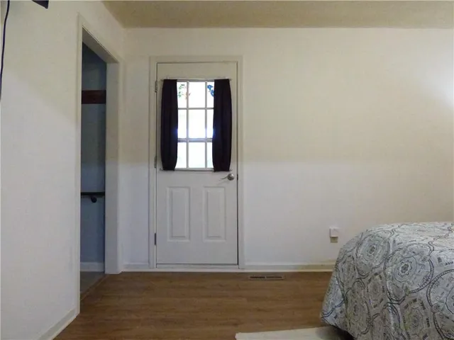 a view of bedroom with window and hallway