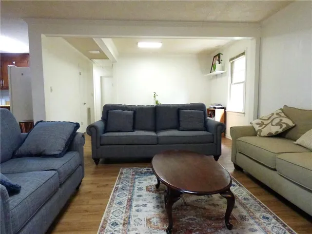 a living room with furniture and a rug