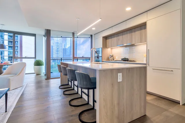 a kitchen with kitchen island granite countertop wooden cabinets and counter space
