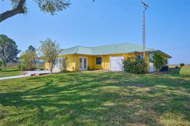 a view of a yard with a house in the background