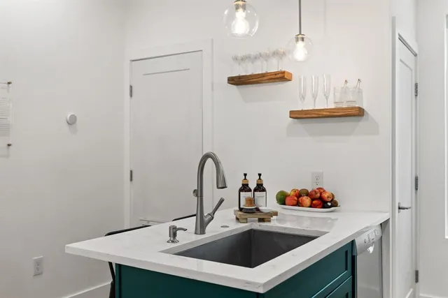a kitchen with sink stove and cabinets