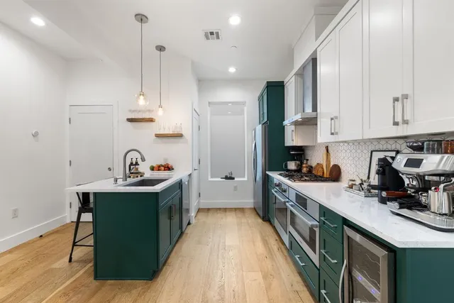a living room with furniture potted plant and a chandelier