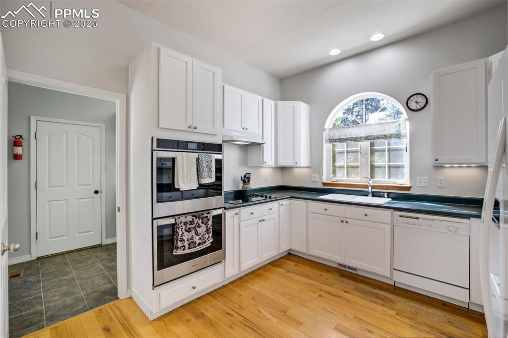 18554 Wetherill Road Monument, CO 80132 - Photo 11 of 50 a kitchen with granite countertop a stove a sink and a window