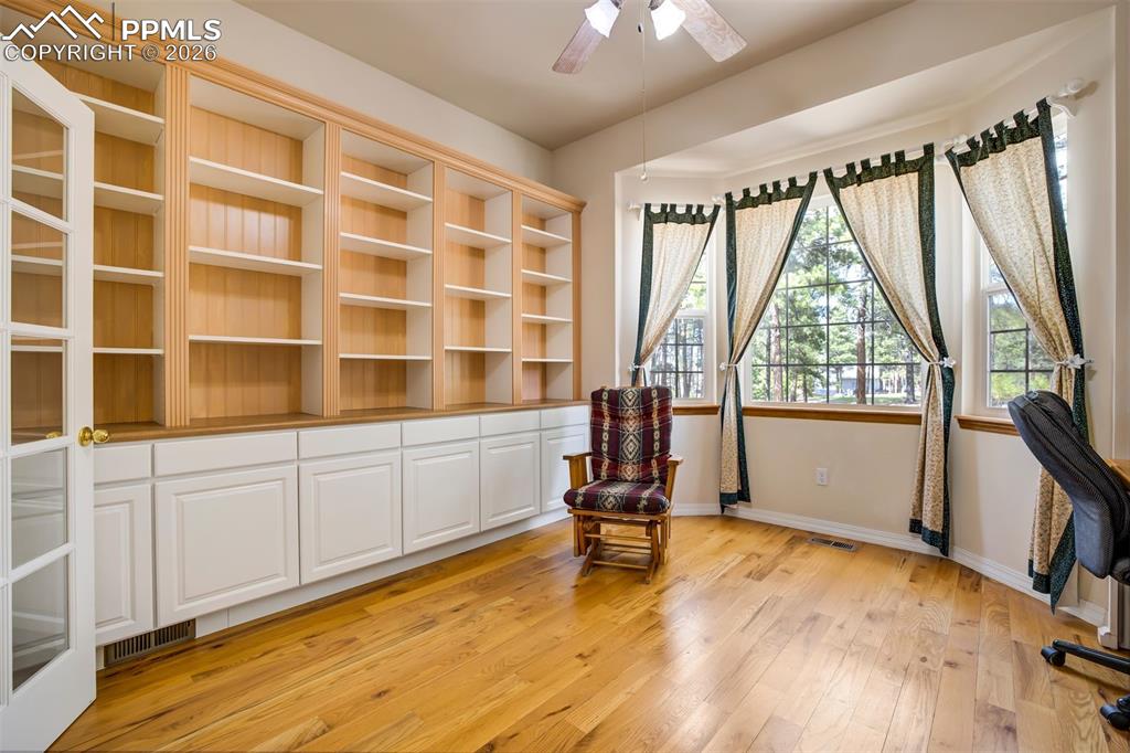18554 Wetherill Road Monument, CO 80132 - Photo 14 of 50 a view of an empty room with a window and wooden floor