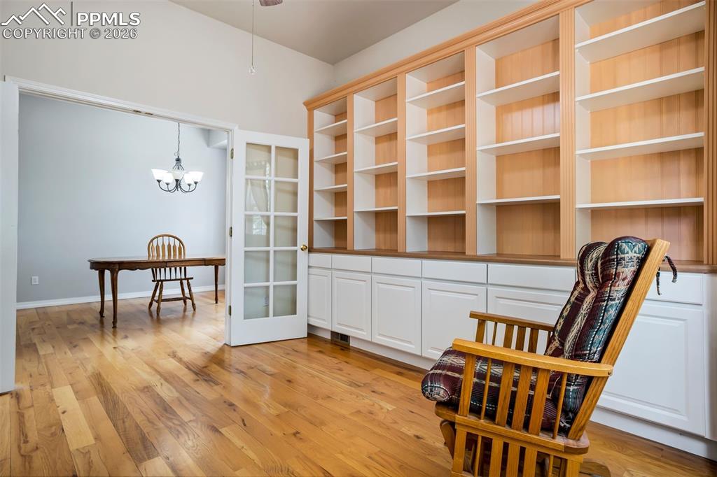 18554 Wetherill Road Monument, CO 80132 - Photo 16 of 50 a view of a workspace with furniture and wooden floor