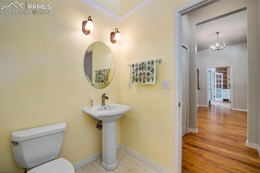 18554 Wetherill Road Monument, CO 80132 - Photo 20 of 50 a bathroom with a sink mirror and toilet
