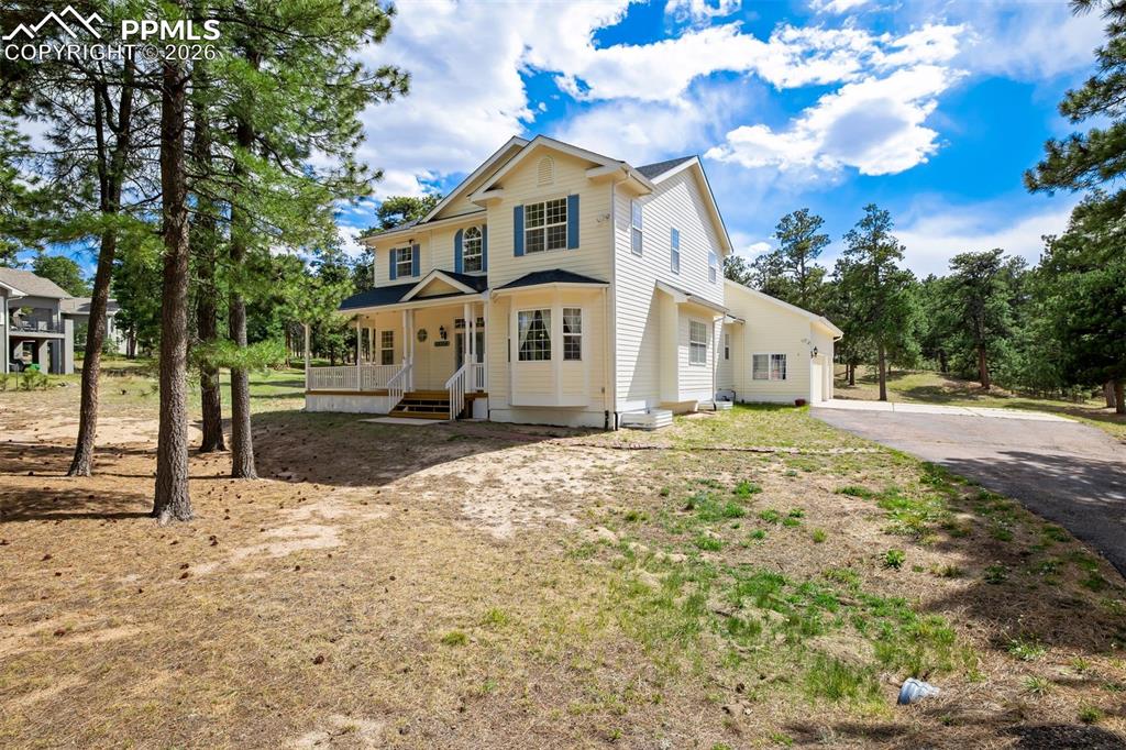 18554 Wetherill Road Monument, CO 80132 - Photo 2 of 50 a front view of a house with a yard