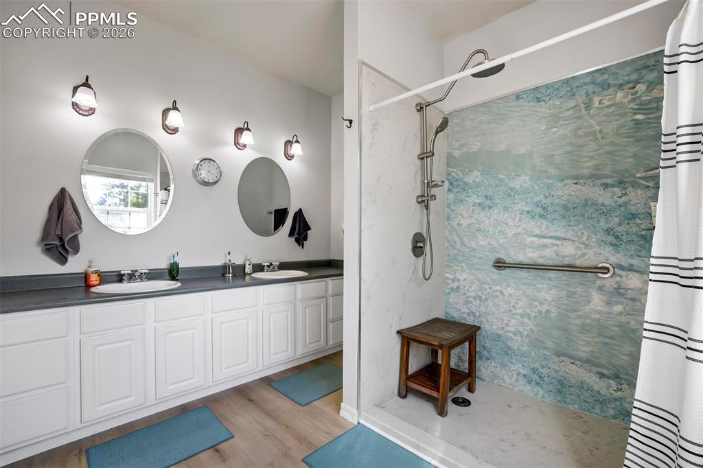 18554 Wetherill Road Monument, CO 80132 - Photo 27 of 50 a bathroom with a double vanity sink and a mirror