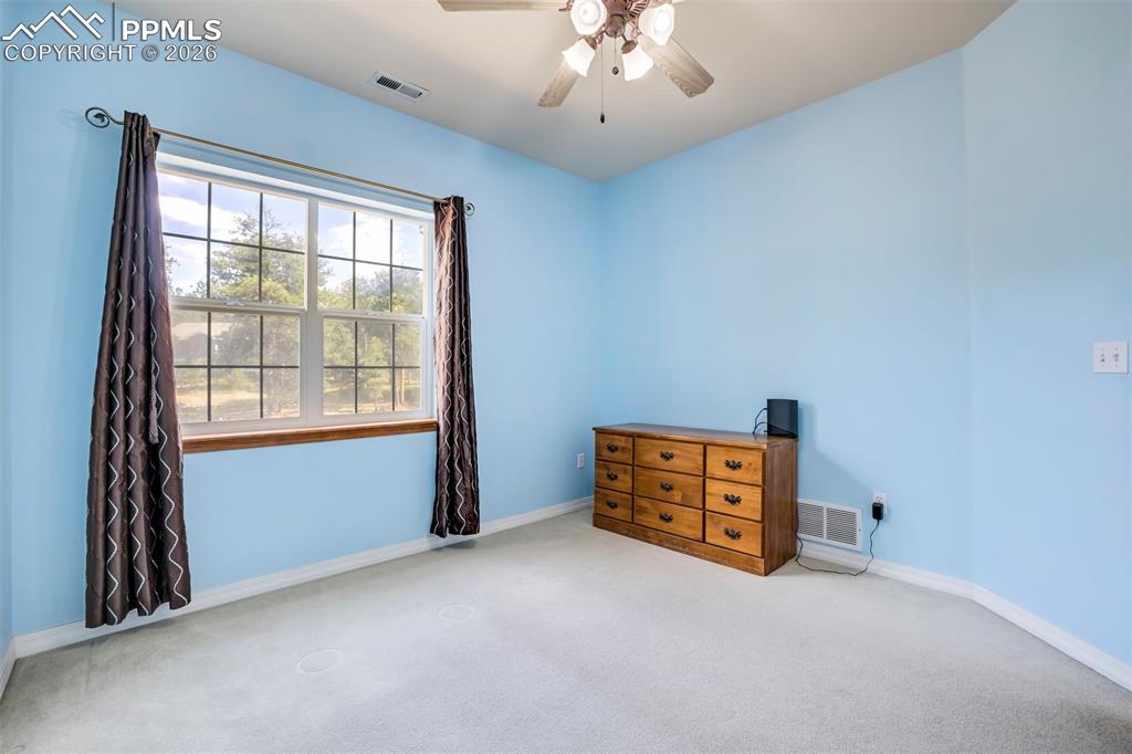 18554 Wetherill Road Monument, CO 80132 - Photo 30 of 50 an empty room with windows