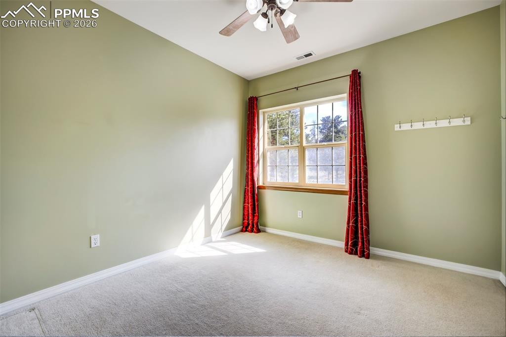 18554 Wetherill Road Monument, CO 80132 - Photo 31 of 50 an empty room with a empty space and windows