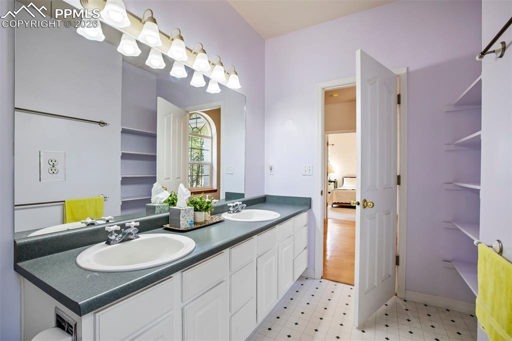18554 Wetherill Road Monument, CO 80132 - Photo 36 of 50 a bathroom with a sink vanity granite tub and a mirror