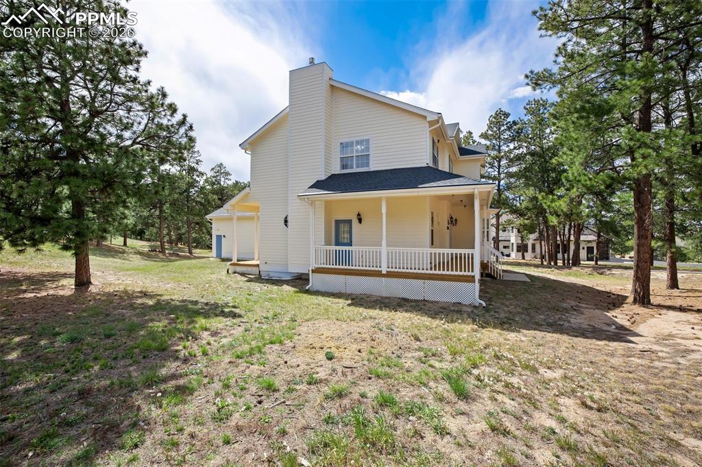 18554 Wetherill Road Monument, CO 80132 - Photo 41 of 50 a view of a house with a yard