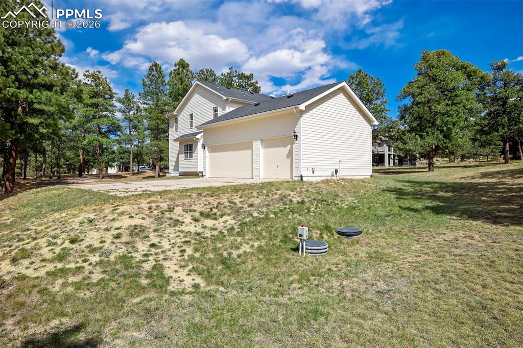 18554 Wetherill Road Monument, CO 80132 - Photo 42 of 50 a backyard of a house with table and chairs
