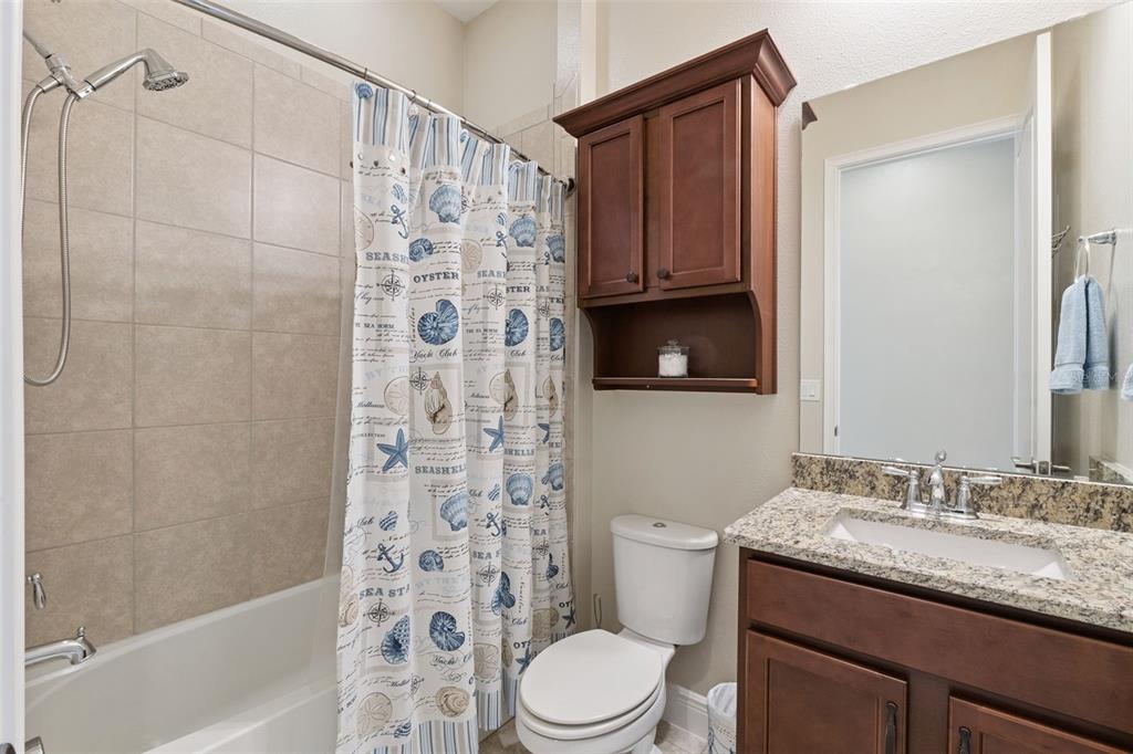 2665 Meadowedge Loop St. Cloud, FL 34772 - Photo 39 of 53 a bathroom with a granite countertop sink toilet and shower