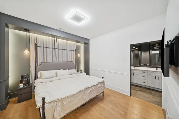 a bedroom with a bed and a flat screen tv