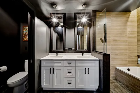 a bathroom with a toilet sink and mirror